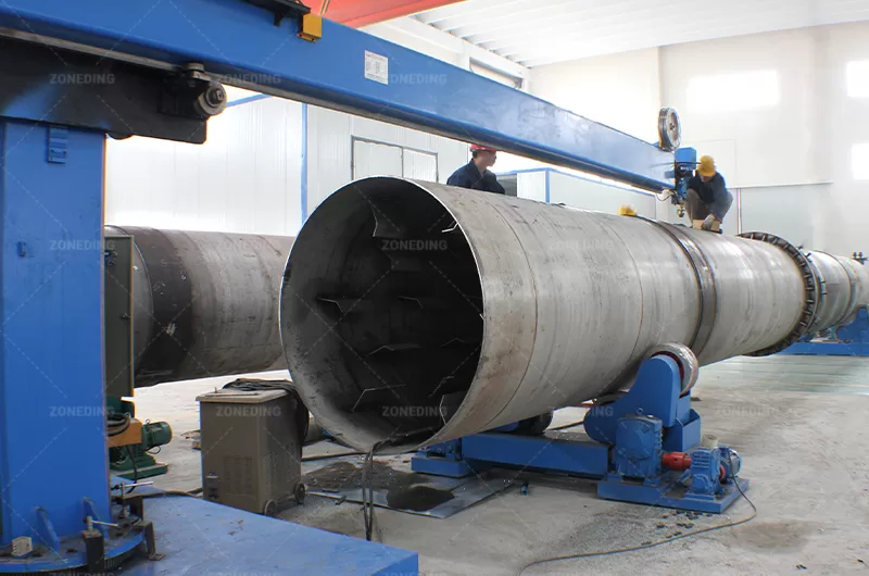 ZONEDING workers are measuring the rotary drum for client specific material like Cassava residue